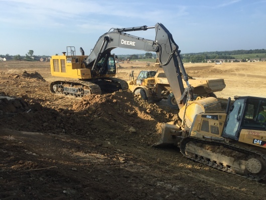crane and bulldozer pushing dirt