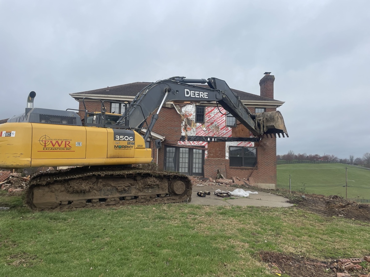 crane tearing down house